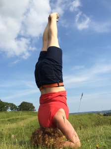 Lara in a yoga headstand in the great outdoors